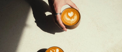 Flat white held by a hand