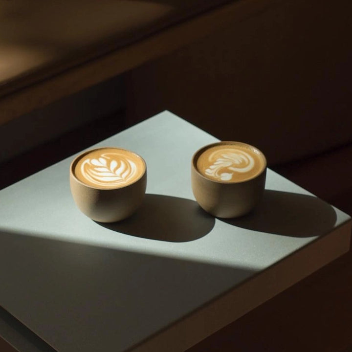 Two flat white cups of speciality coffee