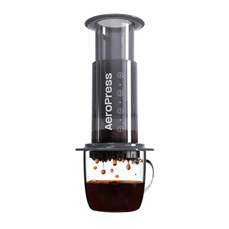 An AeroPress being brewed into a coffee mug